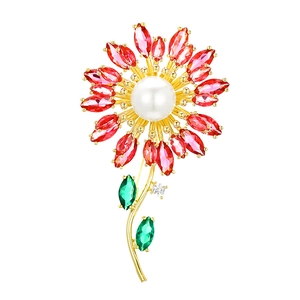 Elegant sunflower brooch with red marquise petals and white pearl center on golden metal