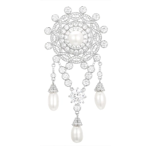Macro shot of sunburst brooch with freshwater pearls and sparkling zircon pavé