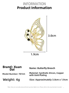 Macro detail of gold butterfly brooch with zircon inlays and hollow wing design
