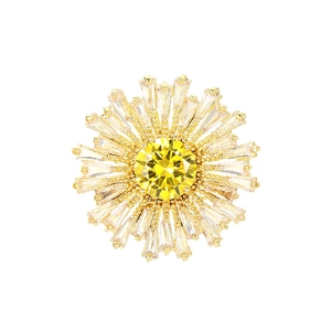 Détail d'une broche florale avec un zircon jaune central et des pétales rayonnants