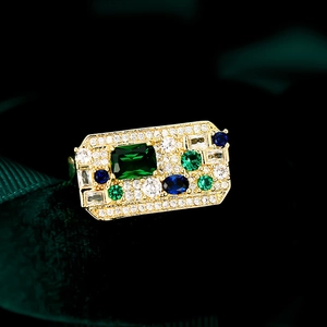 Macro detail of luxury vintage ring with colorful emerald-cut stones and gold plating