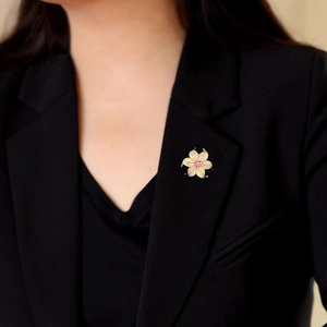 Elegant zircon flower brooch pinned on the lapel of a black professional blazer for women