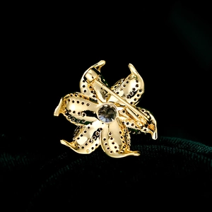 Detailed back view of flower brooch showing honeycomb setting and safety pin closure