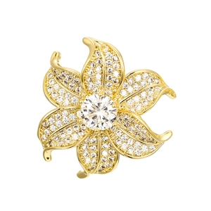 Detail of flower brooch featuring gold finish and micro-paved white cubic zirconia stones