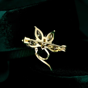 Detailed back view of the orchid brooch showing the secure golden pin clasp mechanism