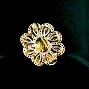Macro shot of the gold metal back and secure pin clasp of a floral zircon brooch