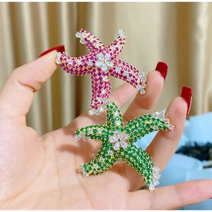 Detailed close-up of colorful starfish brooches with inlaid zircon and crystal embellishments