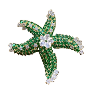 Exquisite starfish brooch featuring green and clear cubic zirconia in a gold setting