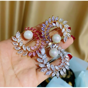Macro shot of luxury crystal floral brooches with marquise-cut stones and white pearls