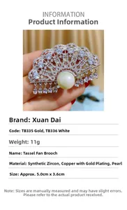 Macro shot of fan-shaped brooch with shell pearls and hanging zircon tassels