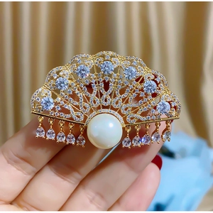 Elegant gold fan-shaped brooch with white pearls and sparkling crystal tassels for women