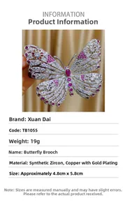 Detalle de broche de mariposa dorado con circonitas incrustadas y corindón sintético rojo