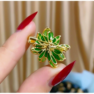 Detailed back view of vintage green enamel leaf brooch with gold metal pin fastener