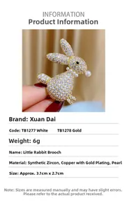 Macro detail of gold-plated rabbit brooch with cubic zirconia and shell pearls