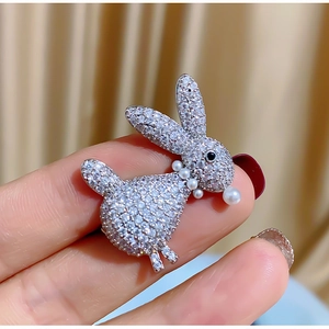 Detailed view of silver rabbit brooch with pave-set cubic zirconia and pearl neck detail