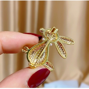 Detailed back view of gold rabbit brooch with cubic zirconia inlay and pin clasp