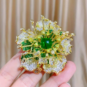 Macro shot of peony flower brooch with green chalcedony and cubic zirconia details