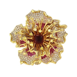 Exquisite gold floral brooch with pink gemstones and large center cabochon stone