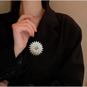 Elegant gold sunflower brooch with multi-layer white and blue zircon on a black blazer