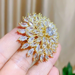 Detailed macro of a multi-layer gold sunflower ring with sparkling marquise zircons
