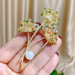 Elegant gold flower brooch with green zircon crystals and a large white pearl pearl