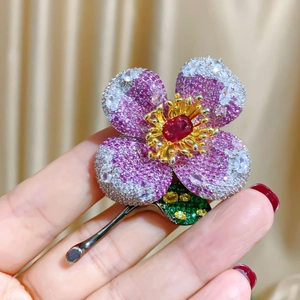 Luxury floral brooch with pink and green pavé crystals in gunmetal plating