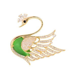 Elegant gold swan brooch with green gemstone and sparkling white crystals for women