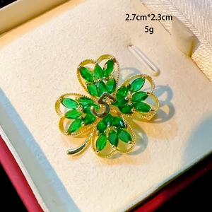 Four-leaf clover brooch in gold finish with green marquise stones and pearl detail