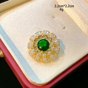 Sunflower brooch with green emerald stone and white zircon petals in gold finish