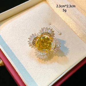 Macro view of luxury four-petal flower brooch with yellow gemstone and clear crystals