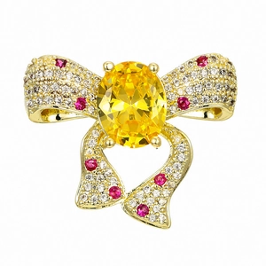 Broche nœud dorée luxueuse avec pierre précieuse jaune et accents de zircon étincelants