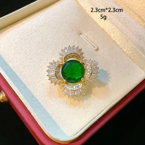 Macro view of clover brooch with green crystal and zircons measuring 2.3cm by 2.3cm