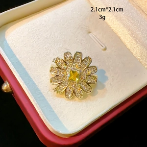 Detail of 2.1cm sunflower brooch with cubic zirconia and yellow center stone