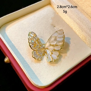 Elegant butterfly brooch with sparkling zircons and white shell wings in a gift box