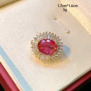 Macro detail of oval ruby red ring with zircon halo and 1.7cm by 1.6cm dimensions