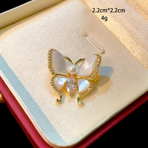 Macro shot of 2.2cm butterfly brooch with natural shell, pearl, and zircon details