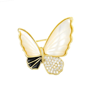 Elegant gold butterfly brooch with natural shell wings and sparkling zircon crystals
