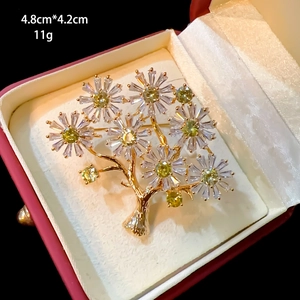 Detailed view of zirkon flower brooch in gold finish showing 4.8cm by 4.2cm dimensions