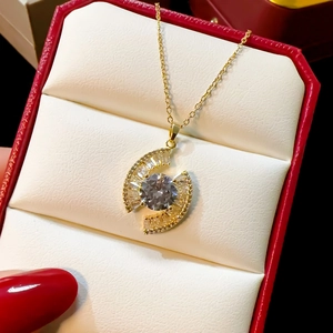 Sparkling gold necklace with round crystal pendant in a luxury red jewelry gift box