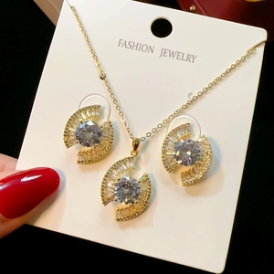 Detail of gold evil eye jewelry set with micro-pave crystals on hand-held display card