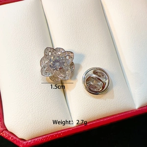 Macro view of 1.5cm silver flower brooch with sparkling cubic zirconia and butterfly clasp