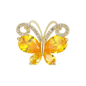Elegant gold butterfly brooch featuring yellow pear-cut stones and sparkling crystals