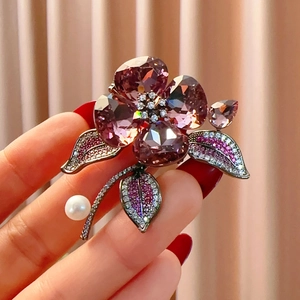 Elegant purple crystal flower brooch with freshwater pearl and sparkling stones detail