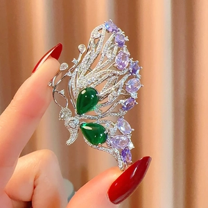 Luxurious butterfly brooch with colorful zircons and green gemstones in silver finish