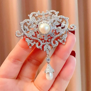 Luxurious French vintage pearl brooch with tassel pendant and shimmering crystal accents