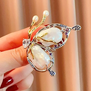 Detail of butterfly brooch with baroque pearls, heart zircon and blue gemstones