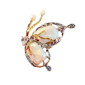 Elegant butterfly brooch featuring natural baroque pearls and colorful zircon stones