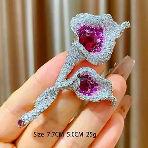 Sparkling calla lily brooch with red heart zircon stones and silver floral metal design