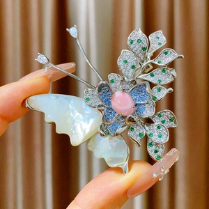 Detail of butterfly brooch with mother of pearl wings and colorful pavé cubic zirconia
