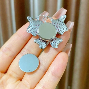 Detailed view of butterfly magnetic brooch featuring pink and purple micro-set zircons